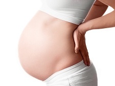 16659893 - pregnant woman with her hands on her back, isolated against white background
